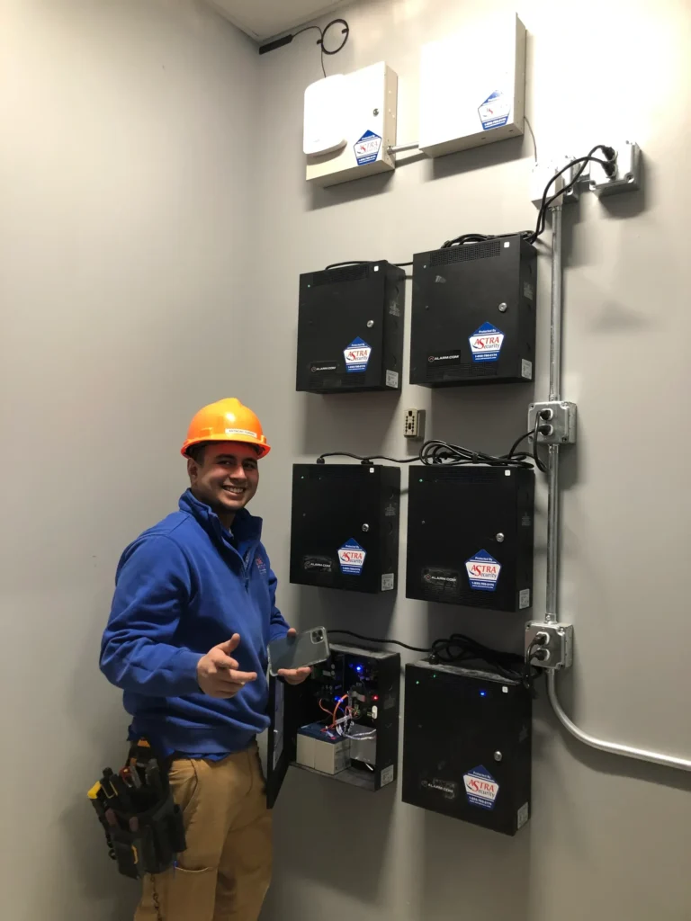 An Astra Security security technician busy installing a commercial security system for one of our Iowa business security clients.
